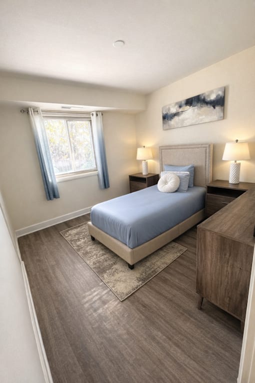 A bedroom with a bed, nightstand, and window at Lawyers Hill Apartments, Elkridge, 21075