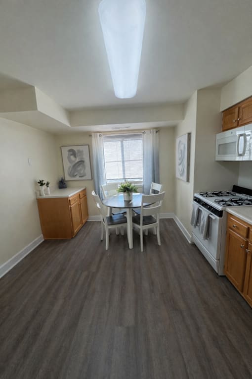 A kitchen with a table and chairs in the middle of the room at Lawyers Hill Apartments, Elkridge, 21075