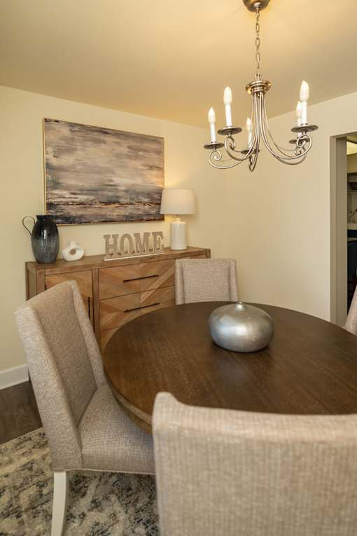 A dining room with a wooden table and chairs at The Brittany Apartments, Maryland, 21208
