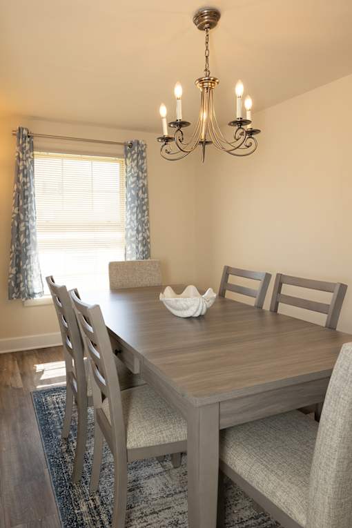 Dining room with window , hanging light fixture, and dining room table