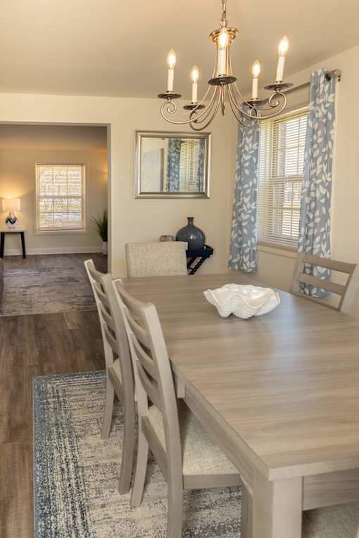 Dining room with window and dining room table looking into living room