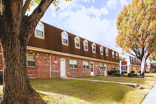 A brown building with a white door and windows at Kingston Townhomes, Baltimore, MD