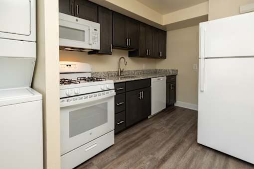 A kitchen with white appliances and a white refrigerator at The Orchards at Severn Townhomes*, Severn, MD 21144
