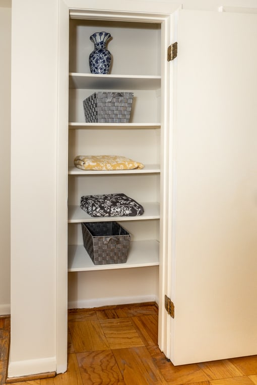 a built in shelving unit with baskets and a vase in the corner of a room at Chapel Valley Townhomes, Baltimore Maryland