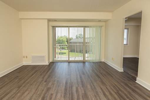 A room with wooden flooring and a sliding glass door at Lawyers Hill Apartments, Elkridge, 21075