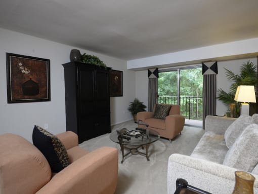Large living room with private balcony at Liberty Gardens Apartments, Baltimore, MD 21244