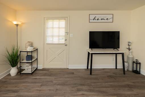 Living room with wood, laminate flooring and side entry door
