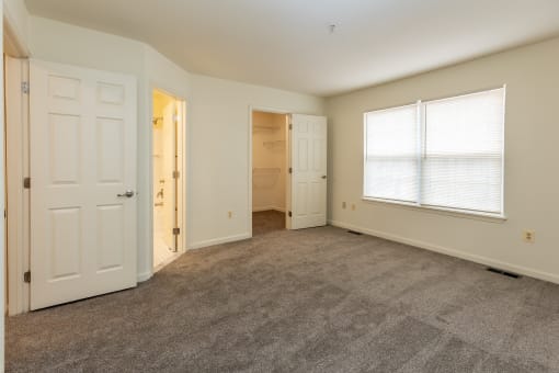Empty bedroom with a closet and a window at Carlson Woods Townhomes, Baltimore