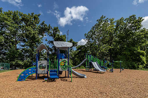 A playground with a blue slide and a green slide at Security Park Apartments*, Maryland, 21244