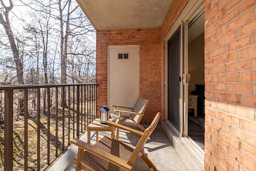 A balcony with a chair and table.