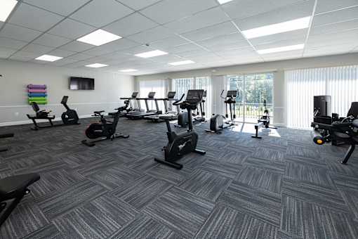 A gym with a variety of exercise equipment.