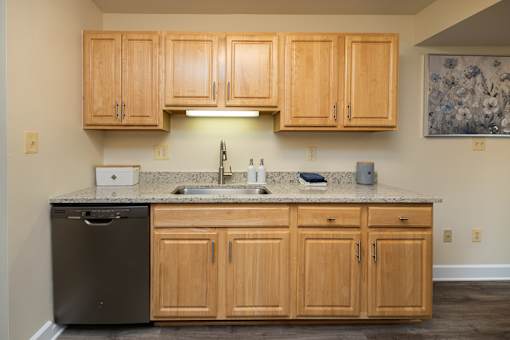 A kitchen with wooden cabinets and a granite countertop  at Ivy Hall Apartments*, Maryland, 21204