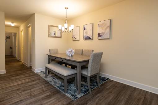 Dining room with a dining table and chairs and a wall with artwork at Village of Pine Run Apartments & Townhomes*, Maryland, 21244
