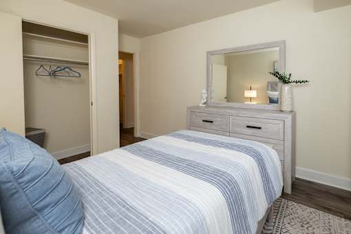 Second bedroom with bed, dresser with mirror, and closet at Village of Pine Run Apartments & Townhomes*, Maryland, 21244