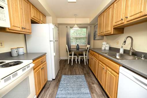 A kitchen with wooden cabinets and a white refrigerator.