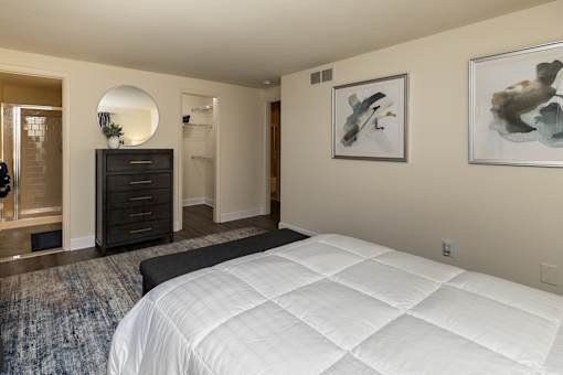 A bedroom with bed and dresser at Spring Hill Apartments & Townhomes, Baltimore, MD 21234