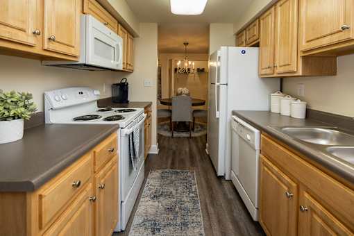Galley kitchen with oven, dishwasher, refrigerator at Spring Hill Apartments & Townhomes, Baltimore, MD 21234.