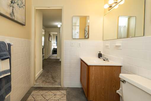 A bathroom with a white sink and a white bathtub.