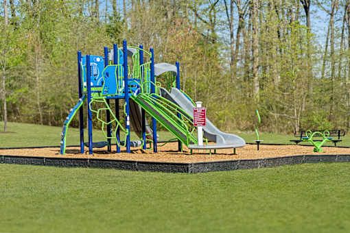 A playground with a blue and green slide.
