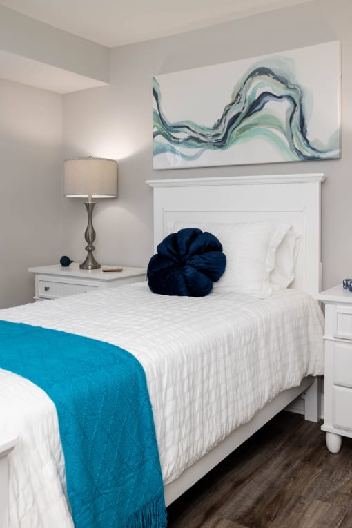 a bedroom with a white bed and a blue blanket at Fairbrook Park, Baltimore Maryland