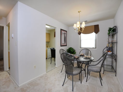 Bright dining room with plush carpet at Rockdale Gardens Apartments*, Maryland