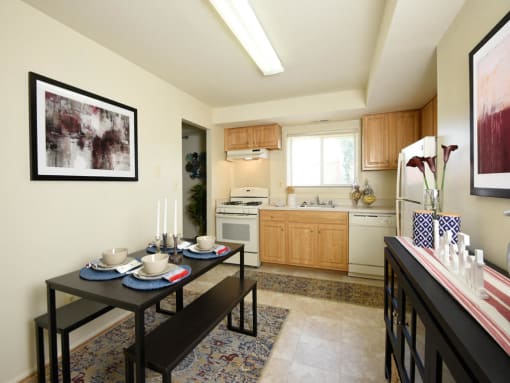 a kitchen and dining room with a table and chairs at Arbuta Arms Apartments*, Maryland, 21230