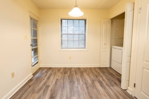 Bedroom with a washer and dryer and a window at Ivy Hall Apartments*, Towson Maryland