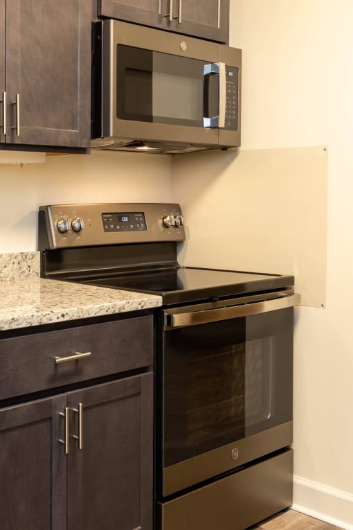 Kitchen with a stove and microwave in a 555 waverly unit at Ivy Hall Apartments*, Towson Maryland
