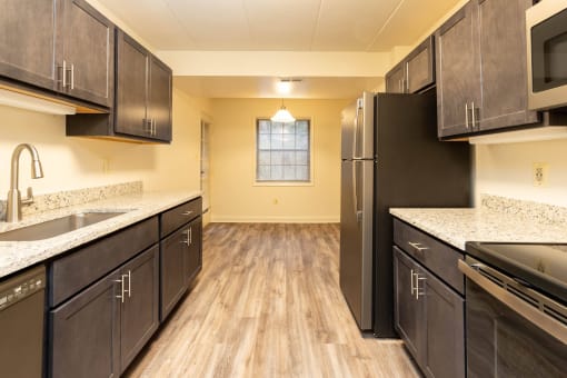 Kitchen with dark cabinets and white countertops at Ivy Hall Apartments*, Maryland