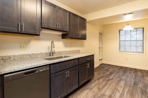 Kitchen with dark cabinets and granite countertops at Ivy Hall Apartments*, Towson