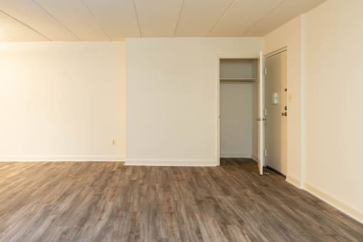 Empty room with white walls and wood floors at Ivy Hall Apartments*, Towson, MD 21204