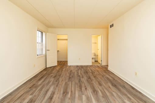 Bedroom with hardwood floors and white walls at Ivy Hall Apartments*, Towson, 21204