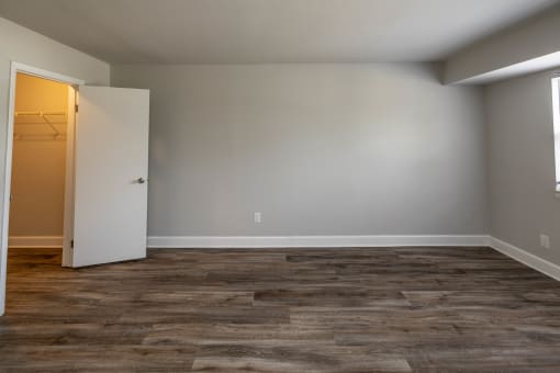 Bedroom with grey walls and a wooden floor at McDonogh Village Apartments & Townhomes, Randallstown, Maryland