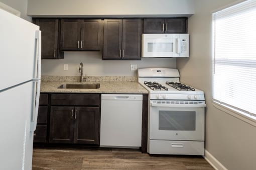 Kitchen with white refrigerator at McDonogh Village Apartments & Townhomes, Randallstown, Maryland
