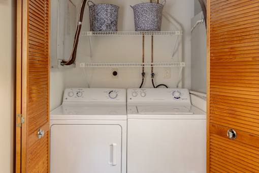 A small laundry room with a washer and dryer.