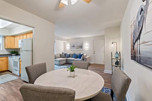 A modern dining room with a round table and chairs at Woodsdale Apartments in Abingdon, MD