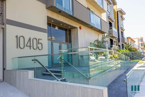 a view of a building with a glass staircase in front of it