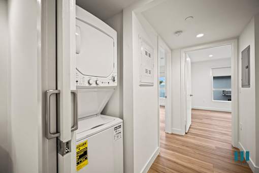 A white fridge with a yellow sticker on it.