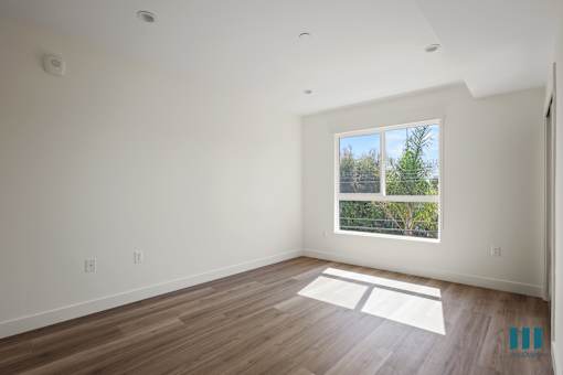 a room with large windows and a wooden floor