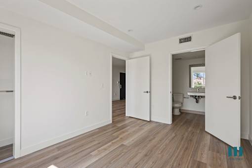an empty living room with white walls and wood floors