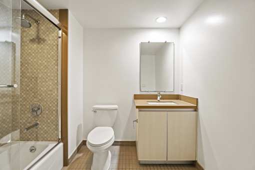 Bathroom with Shower Bath with Glass Door, and Vanity Cabinet Storage