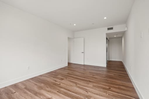 Bedroom with Recessed Lighting, Vinyl Flooring, and Mirrored Closet