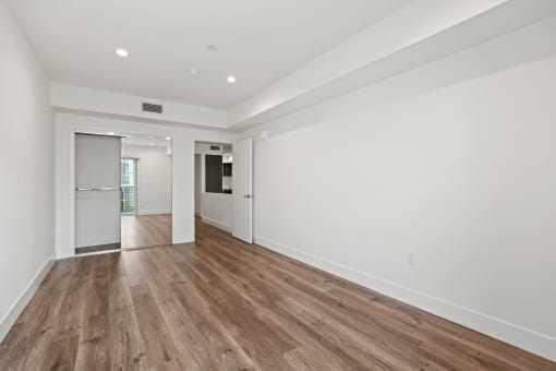 Bedroom with Recessed Lighting, Vinyl Flooring, and Mirrored Closet