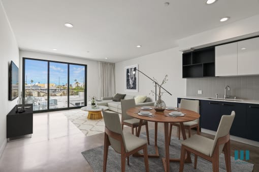 Open-Concept Kitchen, Dining, and Living Room Space with Concrete Flooring and Patio