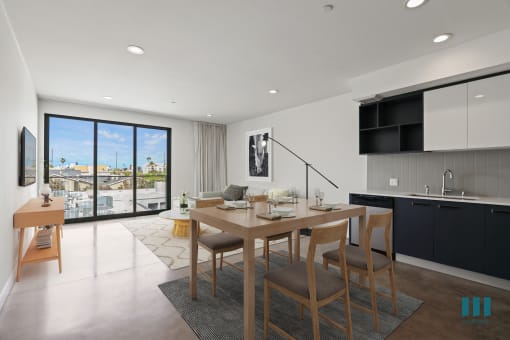 Open-Concept Kitchen, Dining, and Living Room Space with Concrete Flooring and Patio