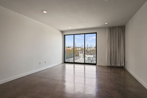 Living Room Area with Recessed Lighting, Polished Concrete Flooring, and Balcony