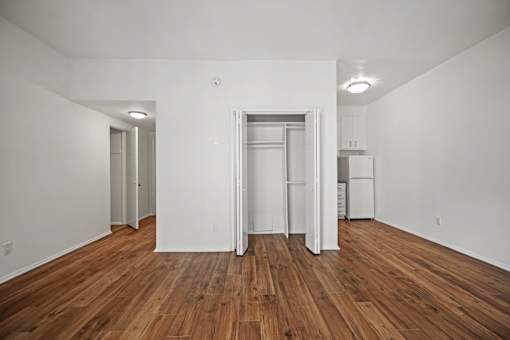 A room with wooden floors and white walls.