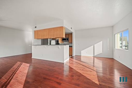 A room with a wooden floor and a white wall.