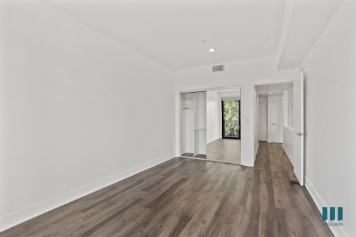 Bedroom with Mirrored Closet, Recessed Lighting, and Vinyl Flooring