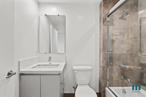 Bathroom with Shower Bath with Glass Door and Vanity Cabinet Storage